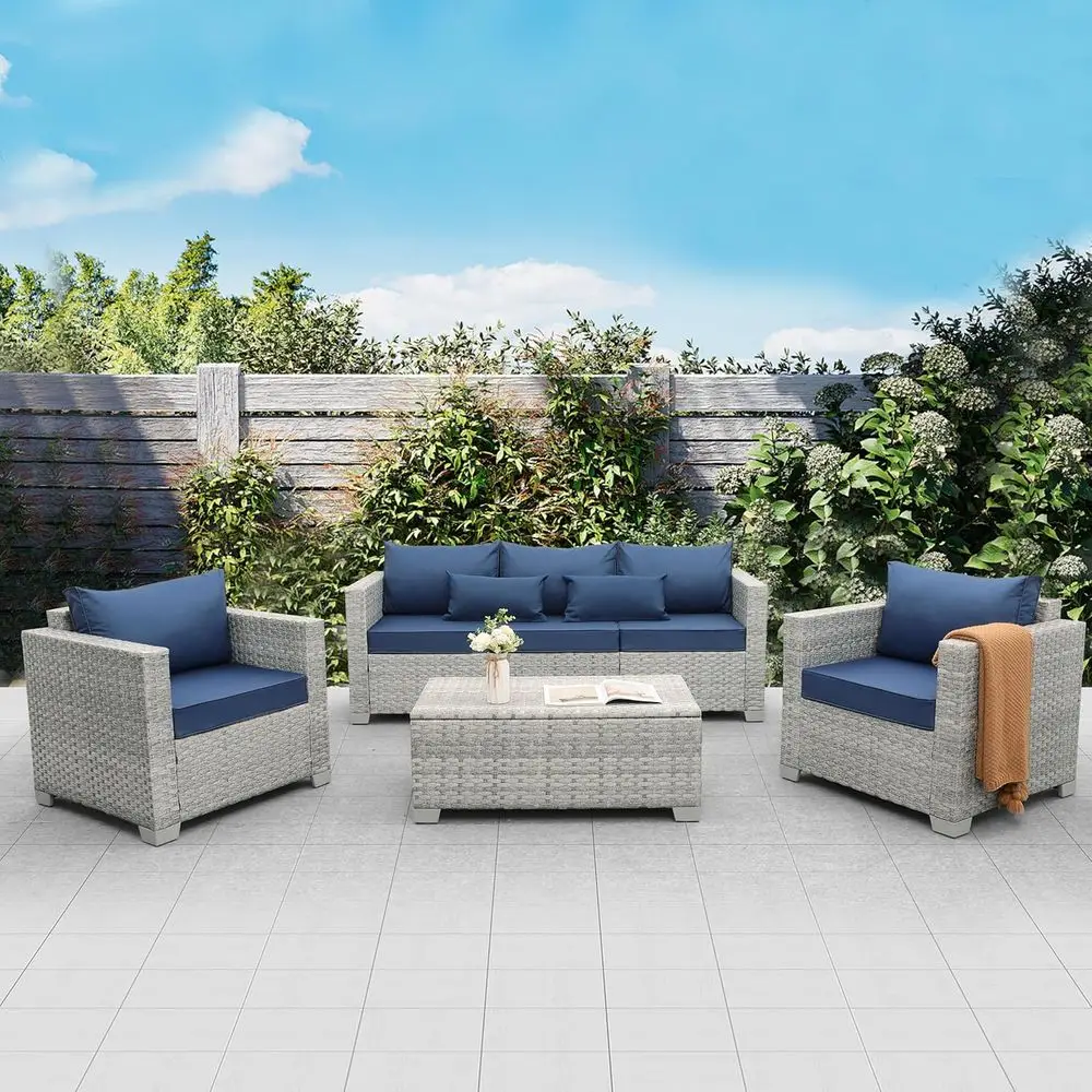 

Комплект уличной плетеной мебели из 4 предметов: секционный диван с темно-синими подушками и столиком для хранения