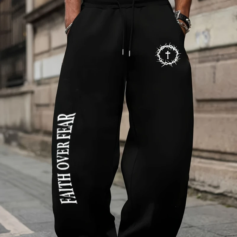 Men's athletic pants featuring the unique "FAITH OVER FEAR" slogan and a graphic print combining a crown of thorns with a cross.