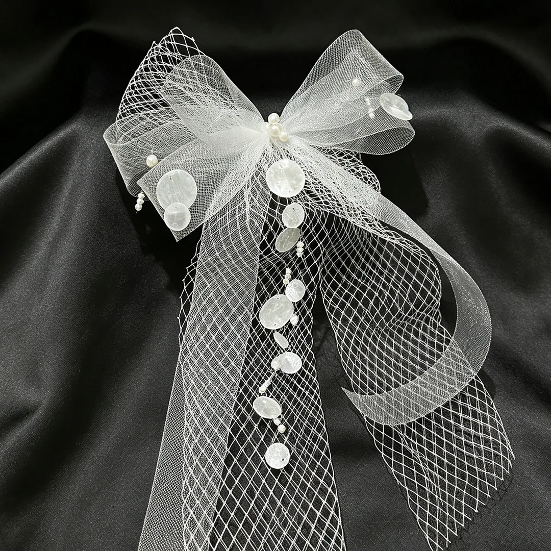Sweet and ethereal bridal headpiece: mori-style tulle bow veil with high-end shell accents and tassel