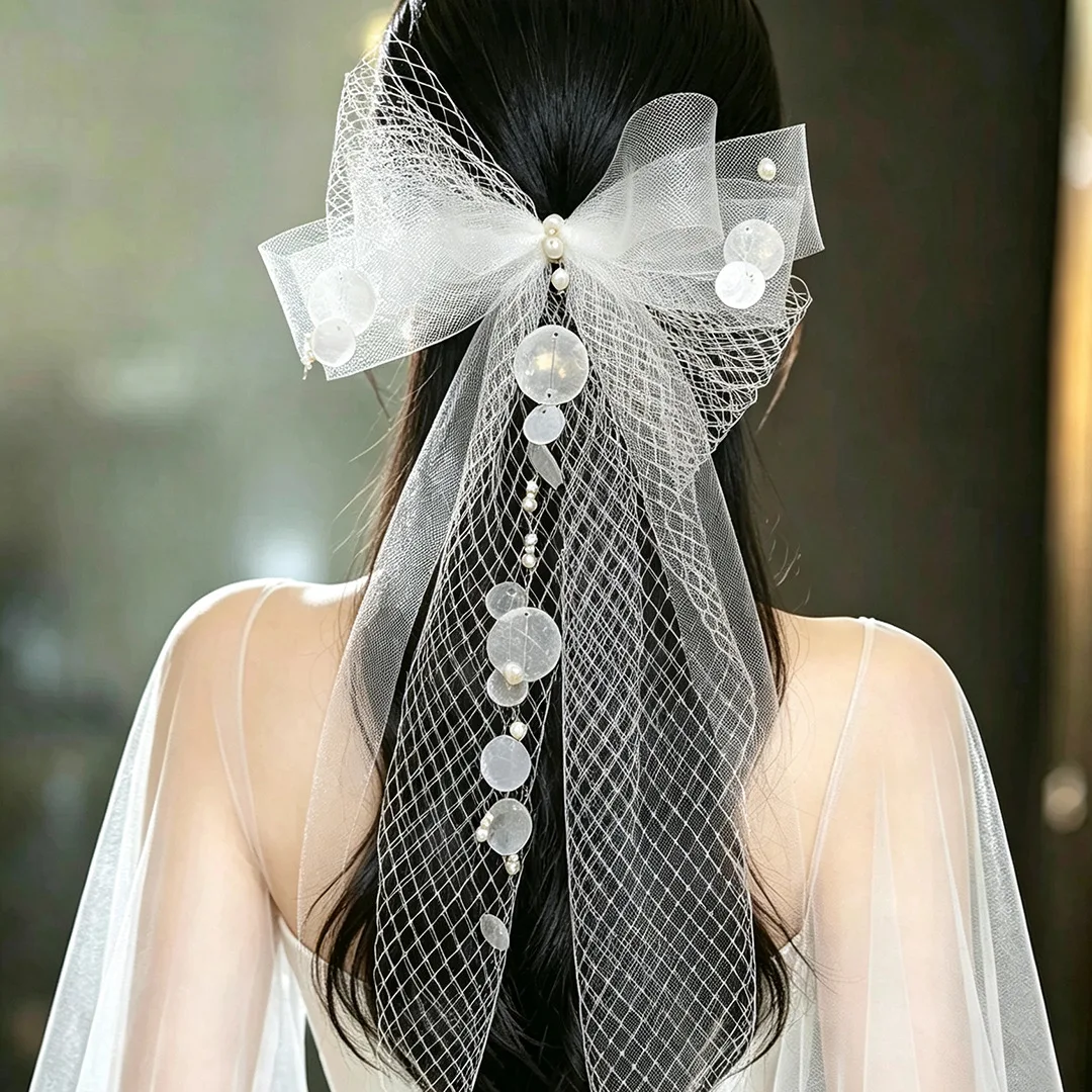 Sweet and ethereal bridal headpiece: mori-style tulle bow veil with high-end shell accents and tassel