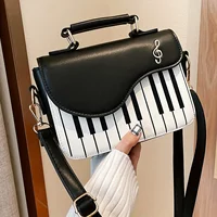 Bolso de mano creativo de cuero PU para mujer y niña, bolso cruzado de moda, notas musicales de guitarra de Piano