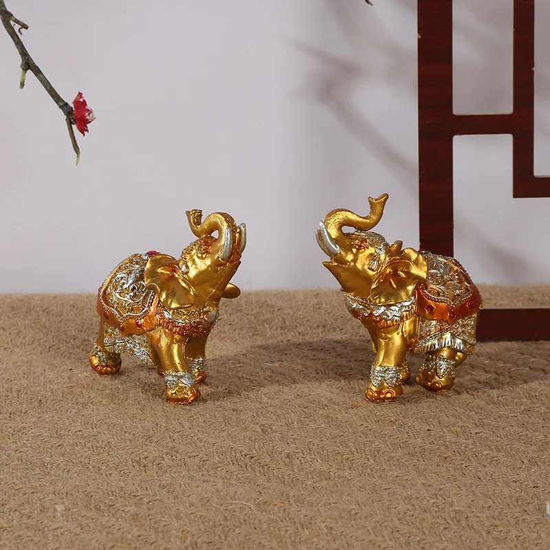 A pair of Thai retro gold elephant resin crafts ornaments office desk bedside table lucky transshipment decoration