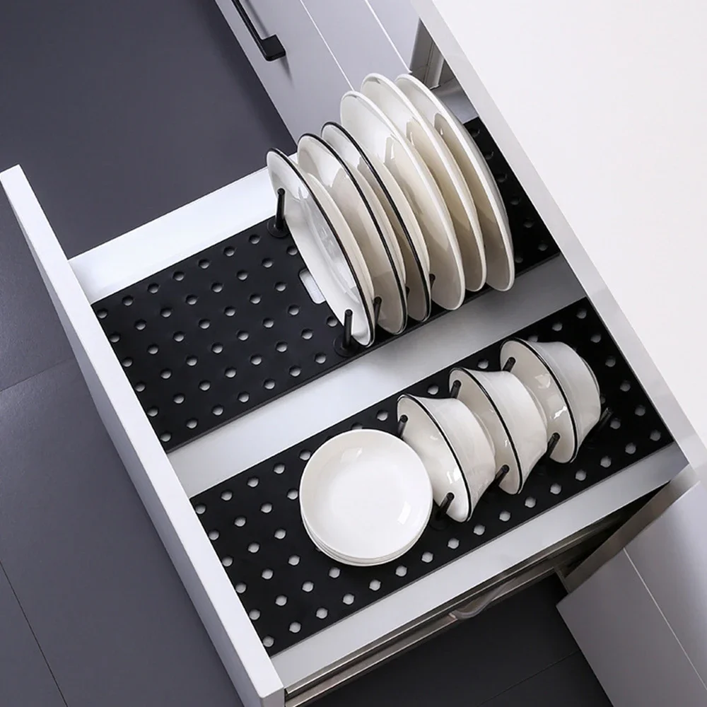 Telescopic dish and plate drying rack with drawer in black on kitchen counter
