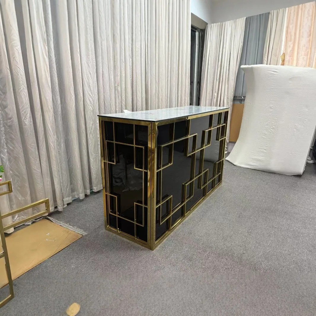 Stainless steel table with gold trim, black table