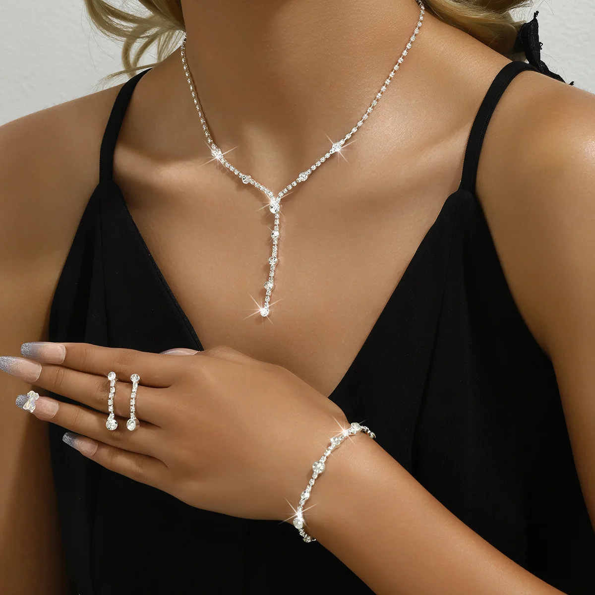 

Newlywed jewelry set including a lady's necklace, earrings and bracelet for evening gown matching