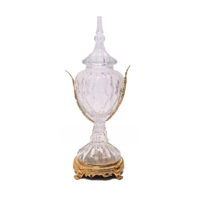 

Antique brass and glass vases with elegant decorative lids, intricately cut glass, and classic gold bases are suitable for