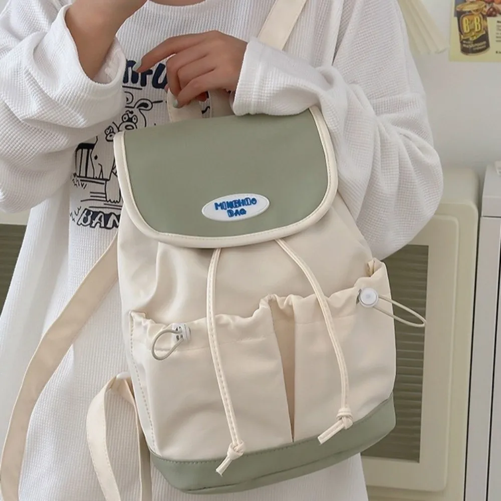حقيبة ظهر بسيطة برباط من النايلون بسعة كبيرة على الطراز الكوري حقيبة كتف متعددة الجيوب حقيبة مدرسية ملونة للطلاب هدية