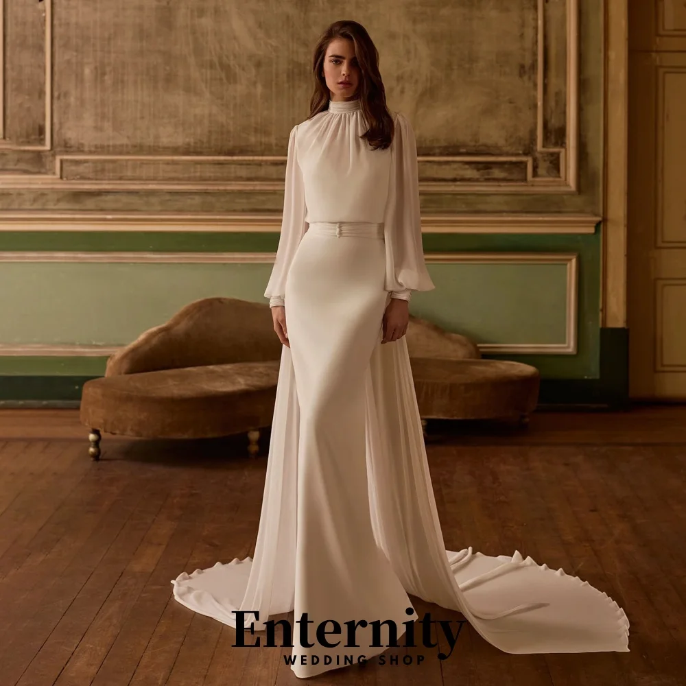 カスタマイズされたバックレスウェディングドレスエレガントなハイネック長袖女性のための魅力的なフリルブライダルガウン Vestidos De Novia