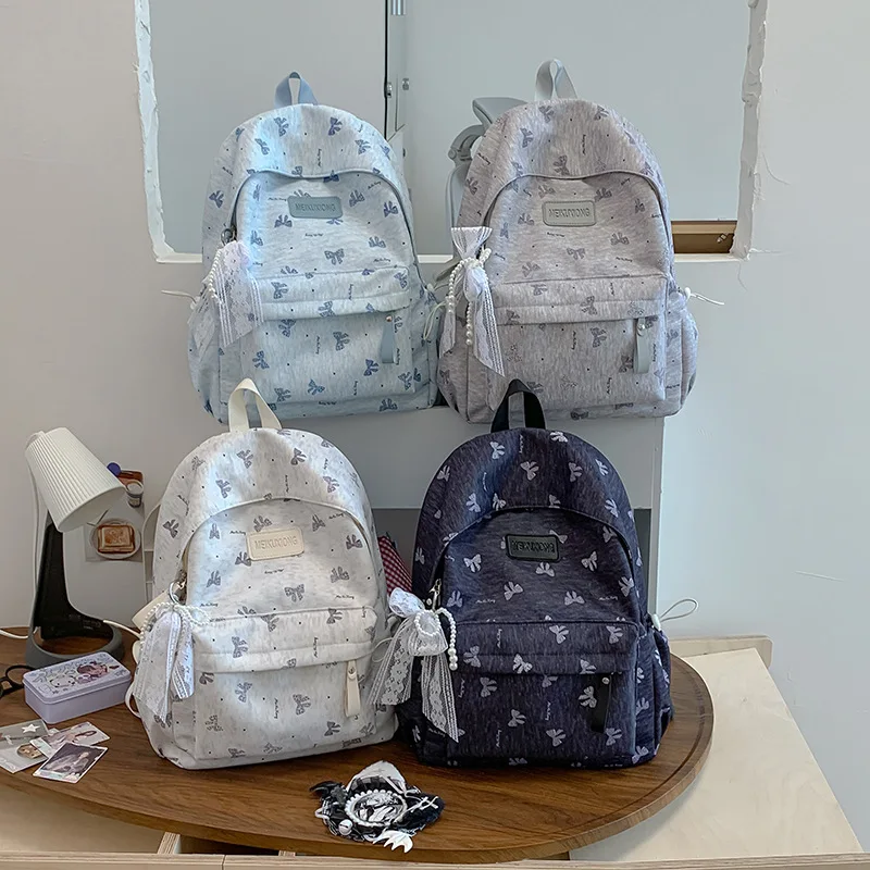 Compact nylon cloth student schoolbag with large capacity, bow-shaped print, water-resistant, women's travel backpack