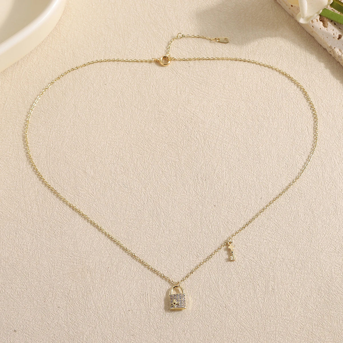 Elegant Gold Plated Starburst Lock and Key Necklace Sparkling CZ Pave Padlock Choker Delicate Asymmetrical Chain Jewelry