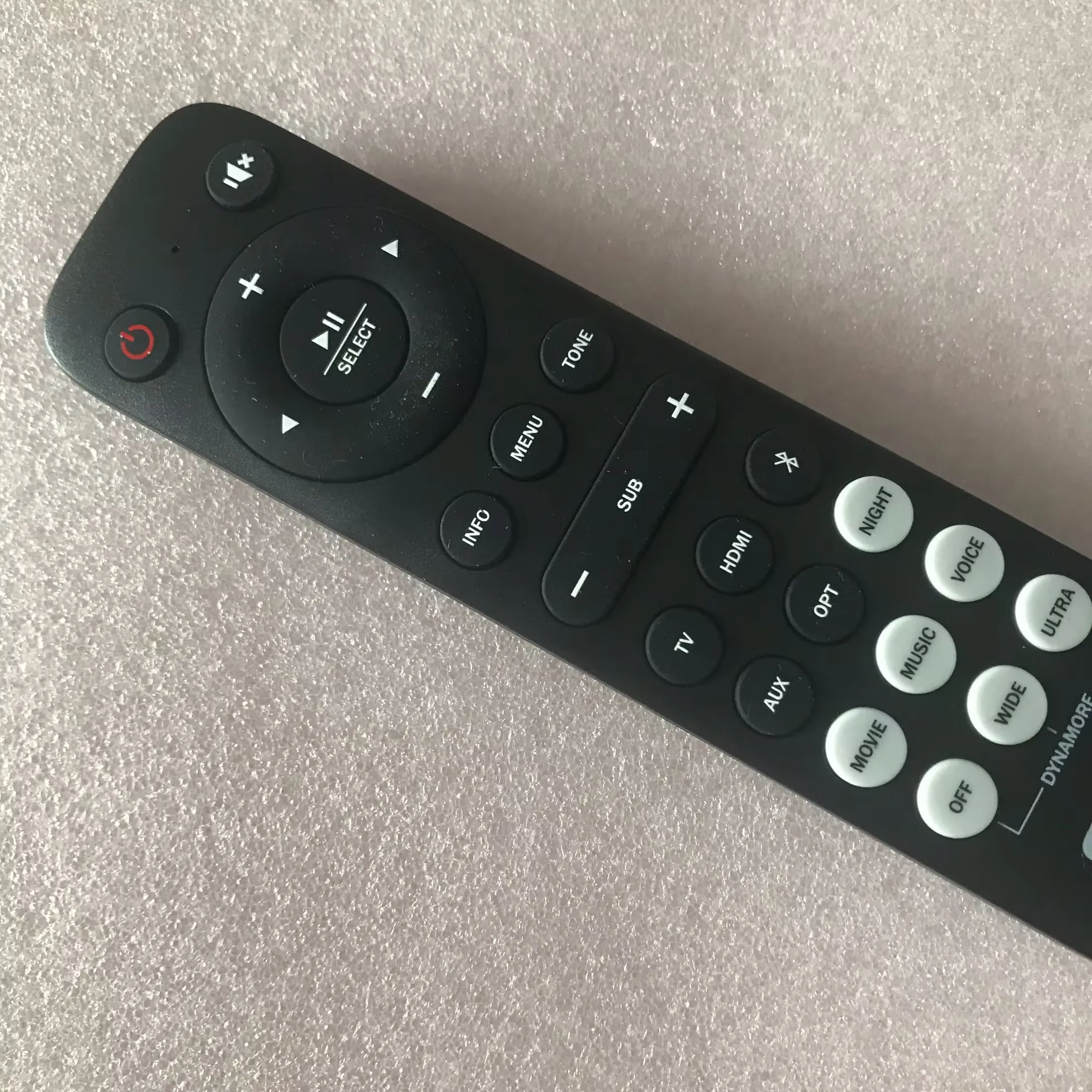 Original remote control for Teufel CINEBAR DUETT soundbar with subwoofer volume and sound effect mode buttons.