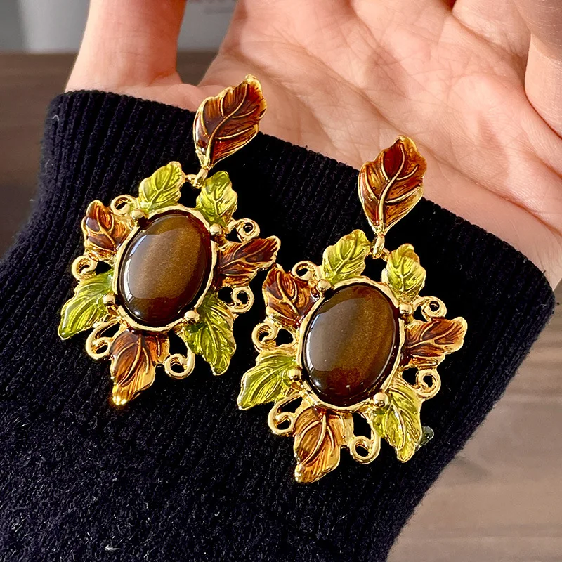 Colorful oil drop enamel gold leaf tiger eye stone glazed earrings surrounded by gold leaves