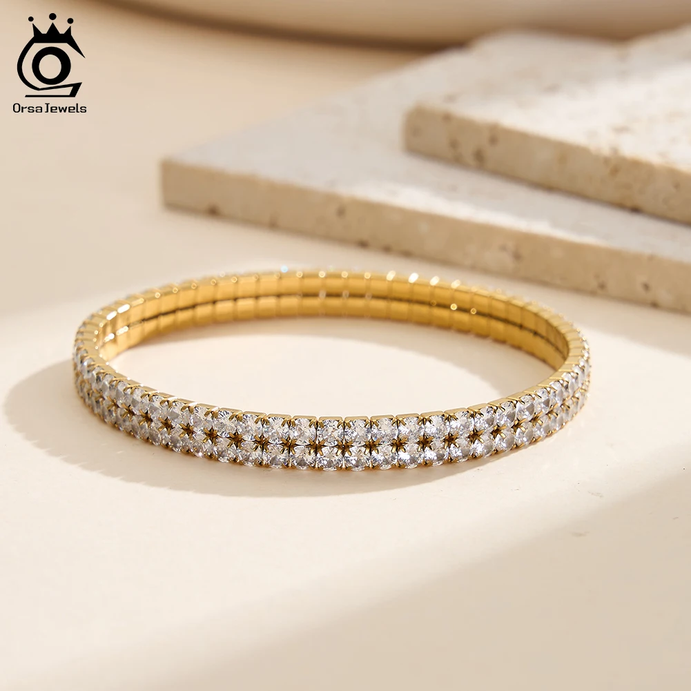 

ORSA JEWELS Браслет из нержавеющей стали с двойными бусинами и белыми цирконами, эластичный, позолоченный, в виде теннисной цепочки, классическое украшение STKB15