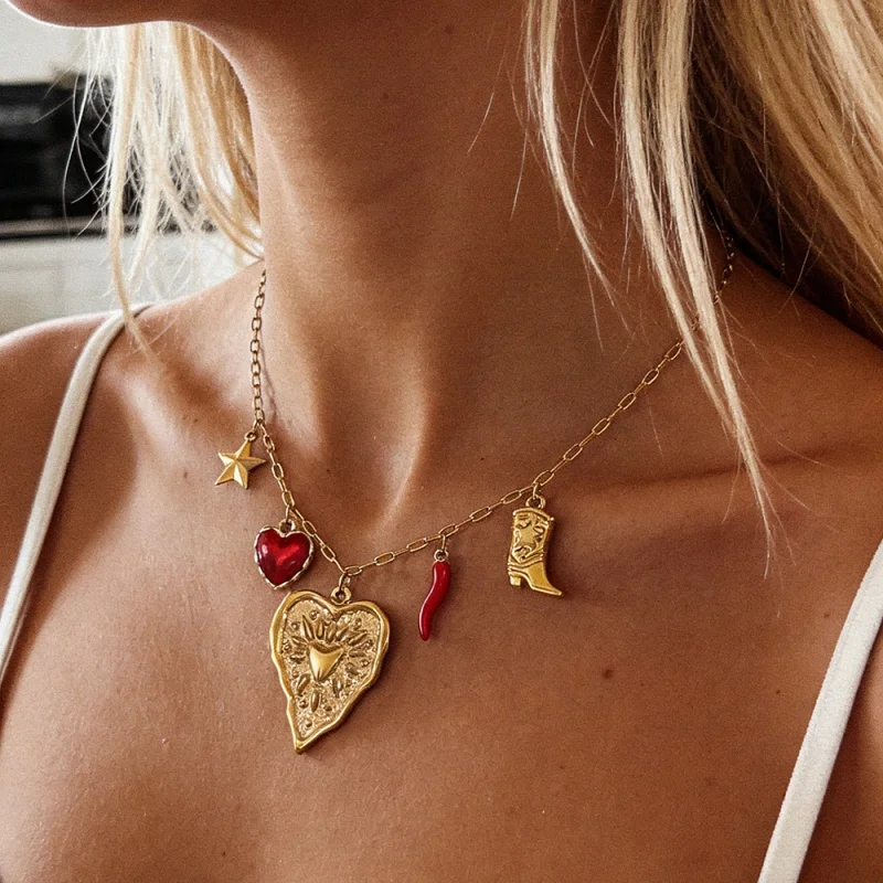 Minimalist and elegant retro titanium steel necklace featuring a heart-shaped, enamel-accented small chili pepper pendant.