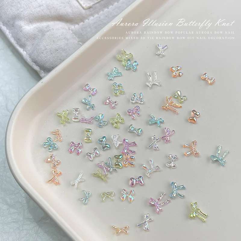 50 ชิ้นที่มีสีสันโบว์เล็บ Charms เล็บอุปกรณ์เสริมศิลปะภาพลวงตา AB สีเรซิ่นริบบิ้น Bows เล็บตกแต่ง Charm