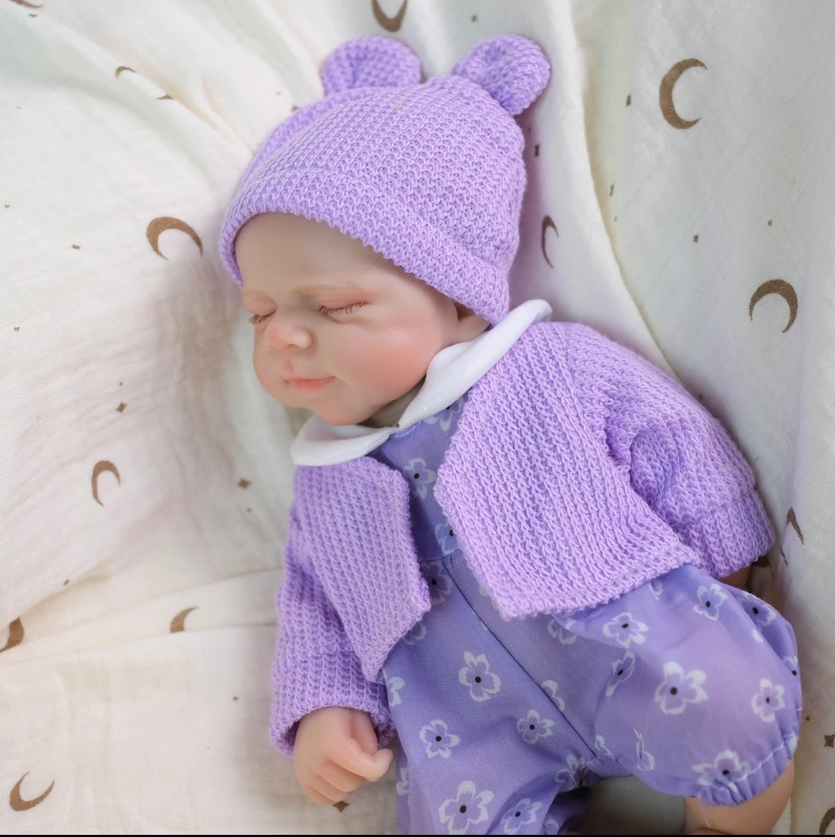 دمية تولد من جديد من السيليكون الصلب مقاس 12 بوصة بجودة الإرث |   يرتدي فستانًا من الزهور الأرجوانية الجميلة مع خدود وردية وابتسامة حلوة