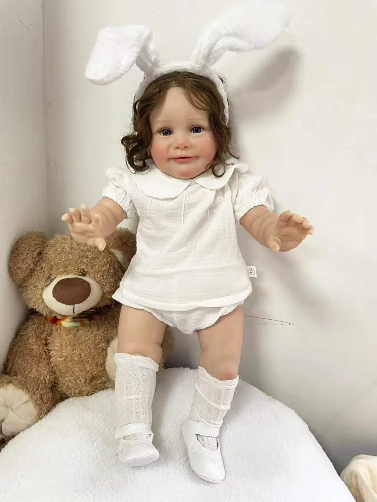 25Inch Lifelike Cute Zoe Reborn Doll Hand Root Hair Wearing A White Short Sleeved Clothing Set and White Rabbit Ear Headband