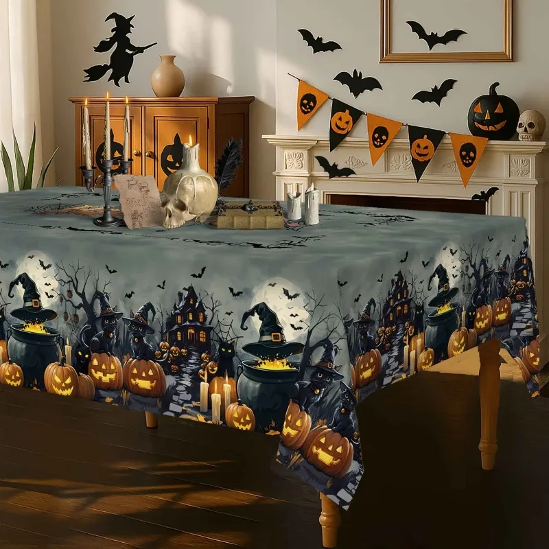 A vintage Halloween tablecloth - with ghosts, castles, bats, black cats, pumpkins and haunted houses -
