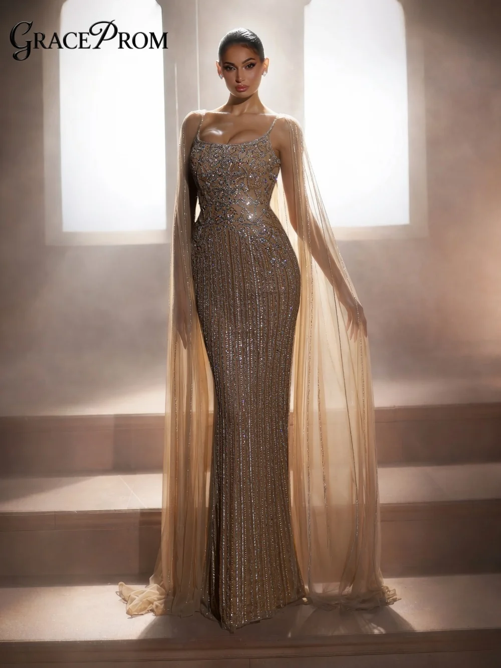 

Glamorous Sheer Cape Sleeve Party Dress 2026 Ethereal Beaded Rhinestone Mermaid Evening Gown For Wedding Guests فساتين سهرة