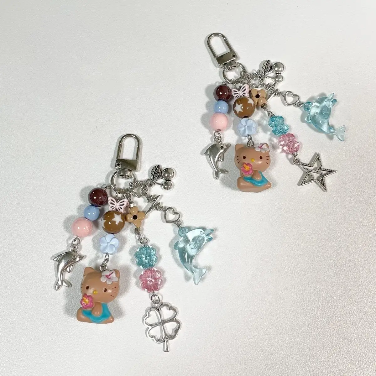 ซานริโอ เฮลโล คิตตี้ ลิตเติ้ล ดอลฟิน หนังสีดำ สายคล้องโทรศัพท์แบบทำมือประดับลูกปัด สายคล้องกระเป๋า สายคล้องกล้อง ของขวัญวันเกิดสำหรับเด็กผู้หญิง