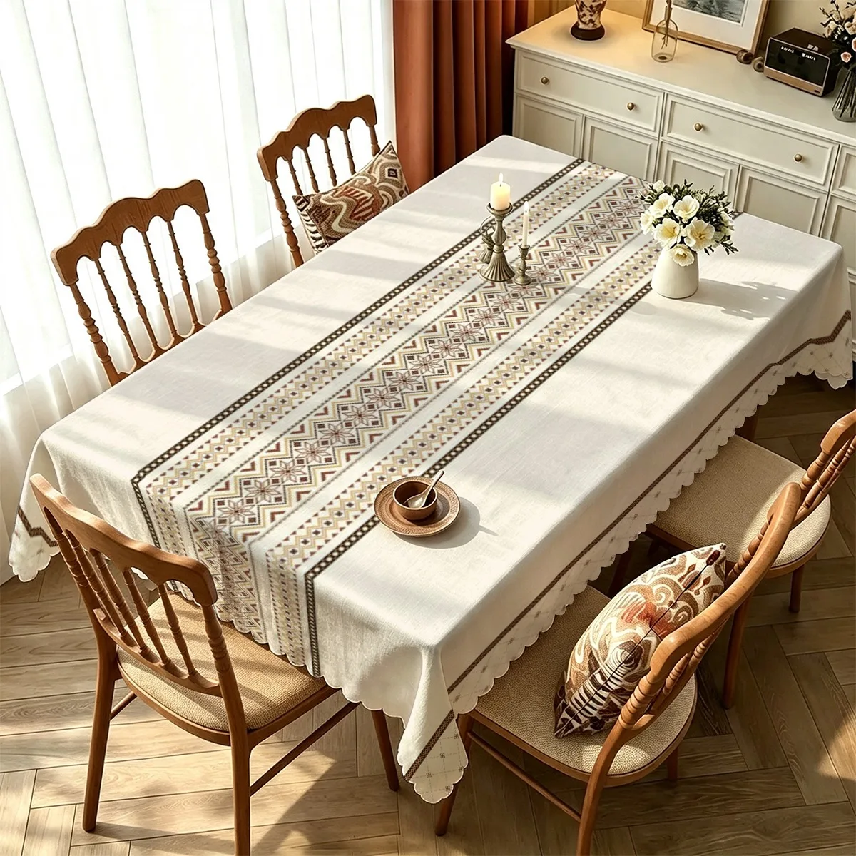 A rectangular tablecloth featuring a pattern of ethnic geometric rhombus-shaped stripes in contrasting colors