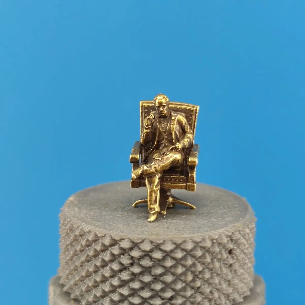 Miniature decorative display model of brass gangster sitting smoking statue