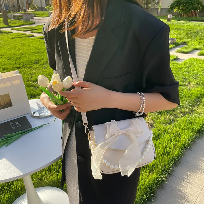 حقيبة كتف السيدات السوداء الكورية القوس عقدة قمة الموضة مقبض حقيبة المرأة قماش كبير الإبط حقيبة 2025 مصمم حقائب اليد الجديدة bolsas