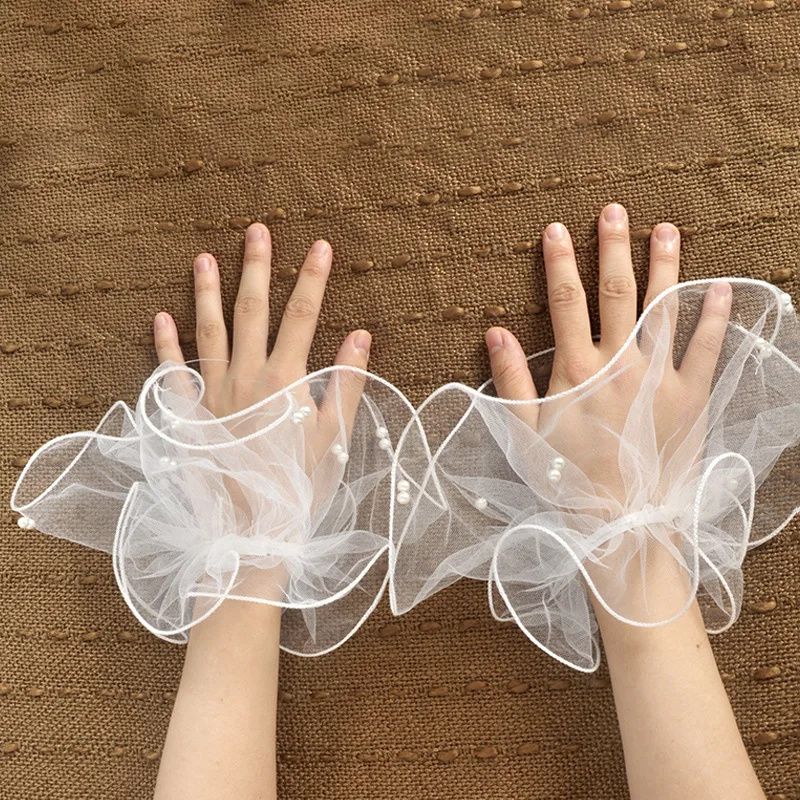 A short pearl tulle roll-up edged beaded bridal glove for a summer wedding ball party worn elegantly with fingerless sleeves