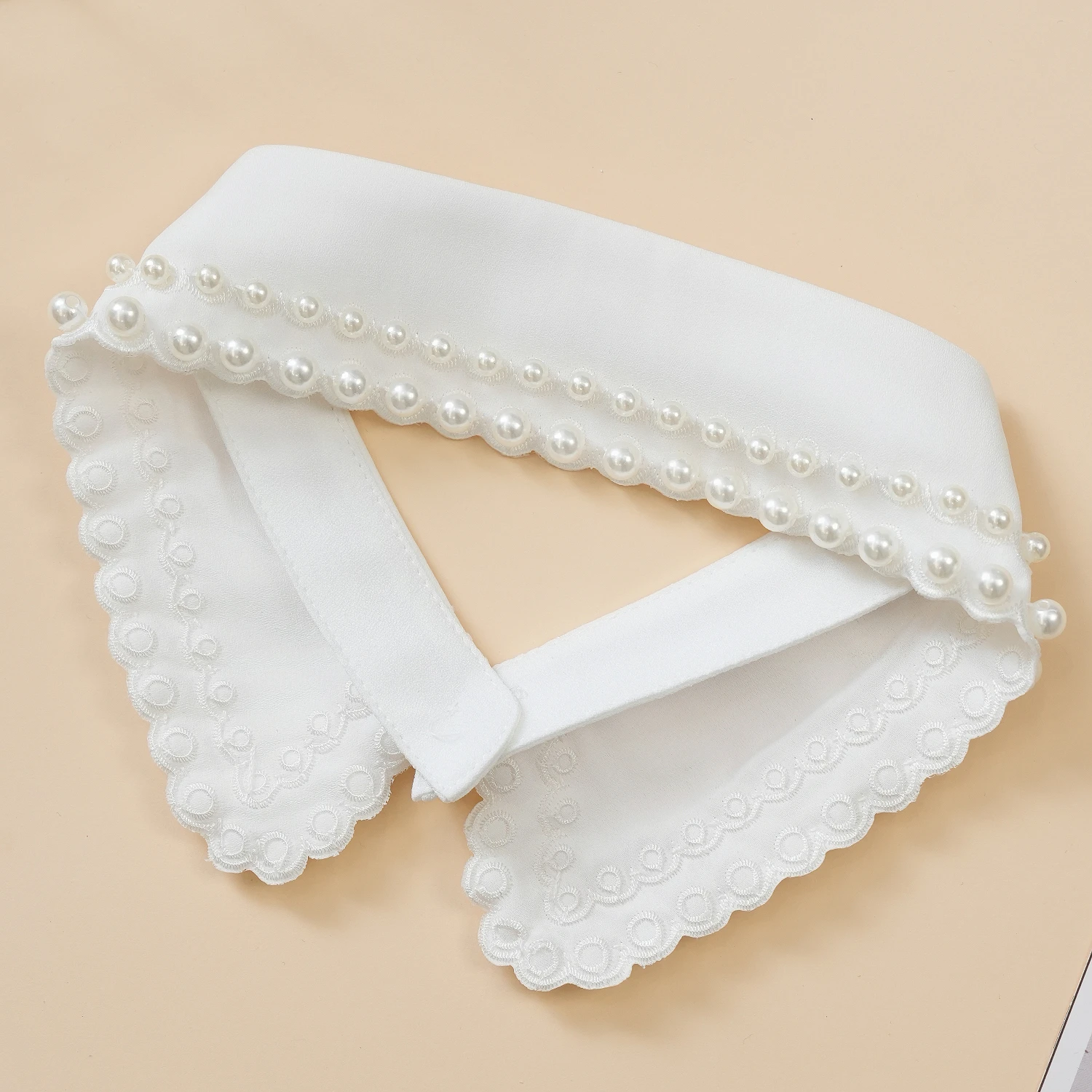 A fashionable, versatile and trendy lace false collar for women, decorated with beads and featuring hollow-out designs. It has a