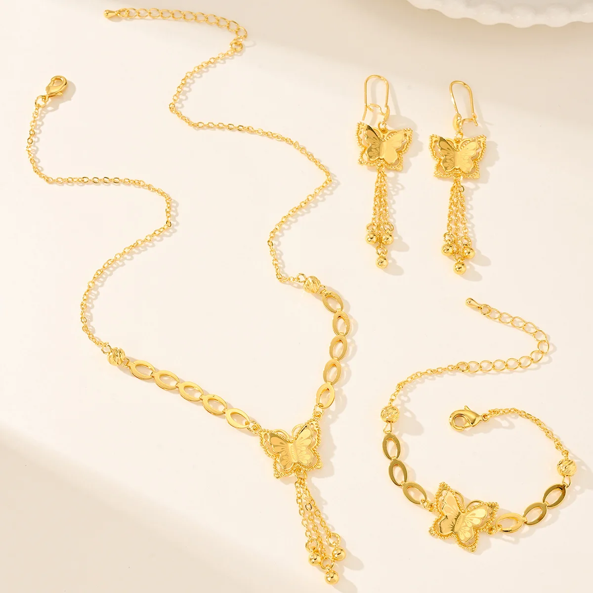 9999 gold three-piece butterfly jewelry set. Manufacturer for wholesale of cross-border necklaces, earrings and bracelets