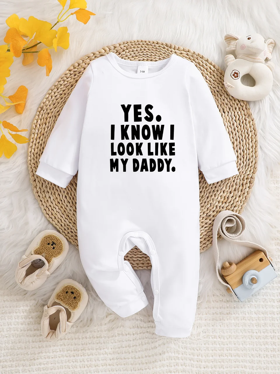 A baby long-sleeved onesie with interesting letter prints. It features a buttoned design for easy putting on and taking off, and