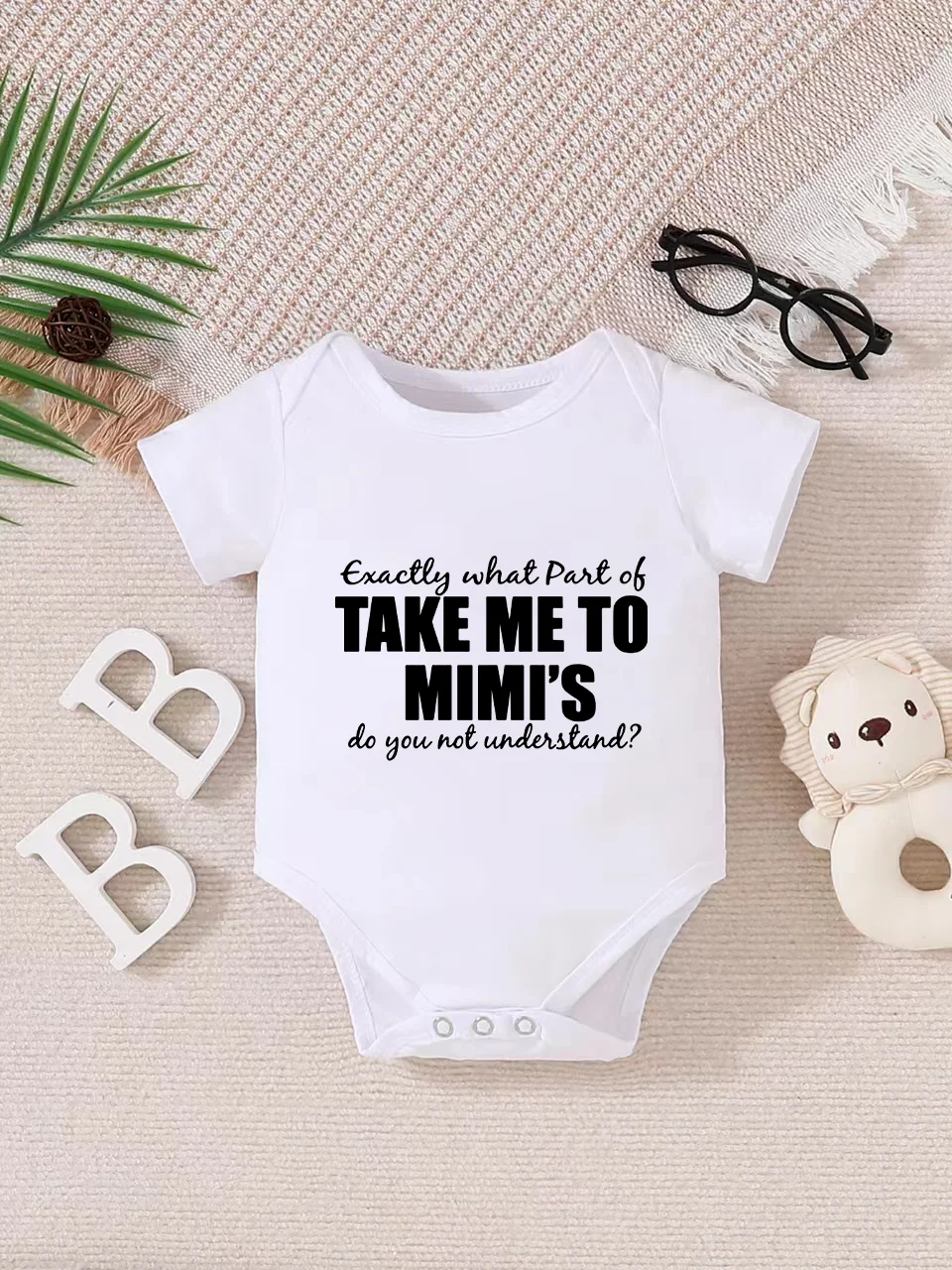 Playful letter-printed baby short-sleeve triangle bodysuit. Button closure for easy dressing, machine washable