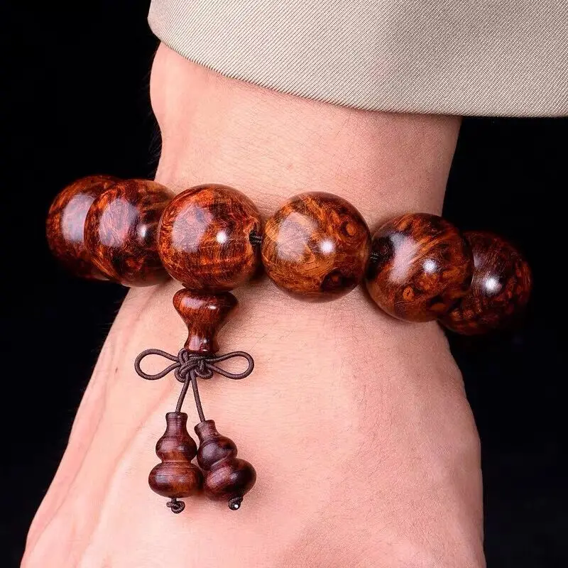 

Hainan Huanghuali Burl Men's 20mm Gall Tumor Ghost Face -to-Eye Full Water Wave Tiger Leather Bracelet