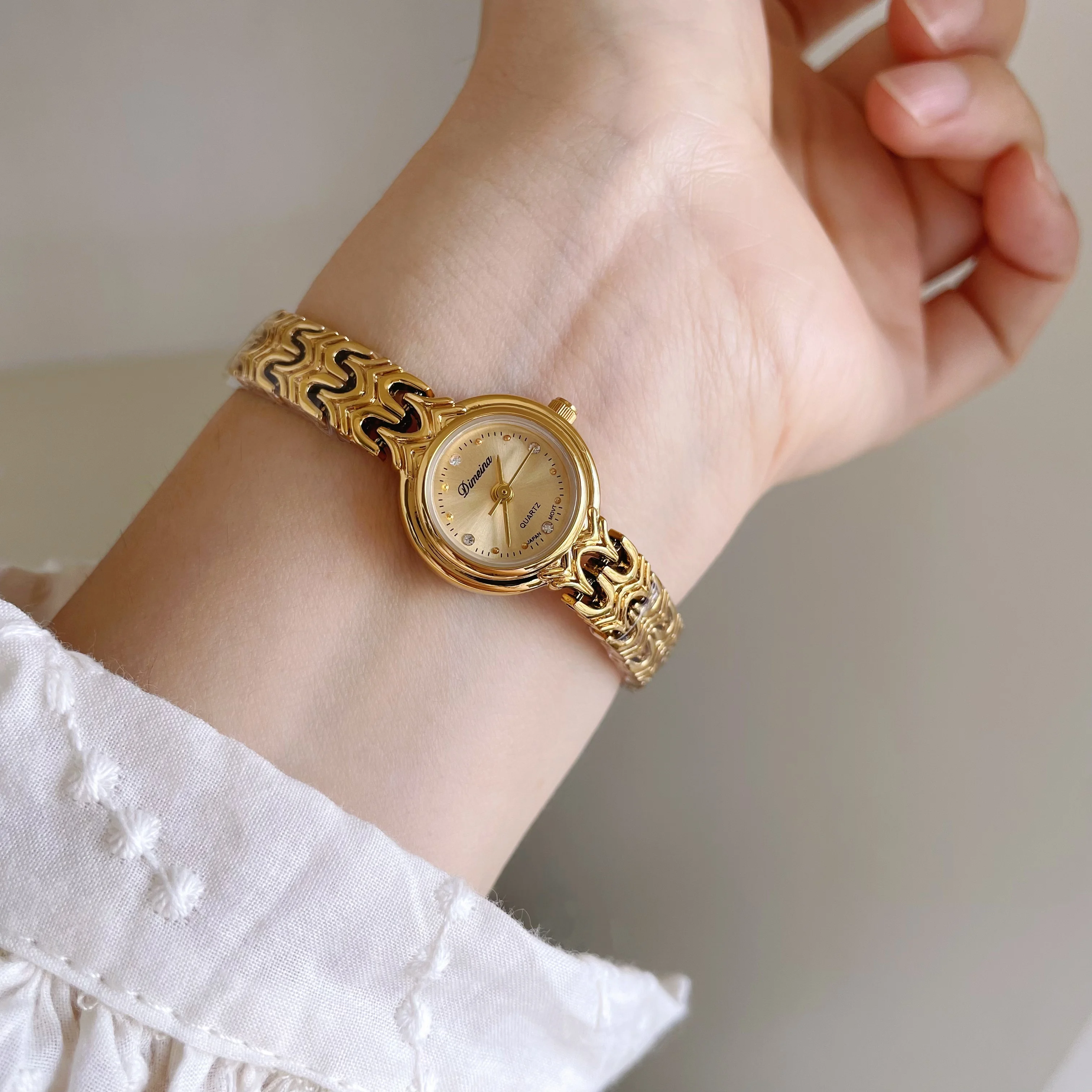 Mini gold retro-style watch with a small dial and openwork strap; a luxurious quartz watch for women; a perfect gift for women.