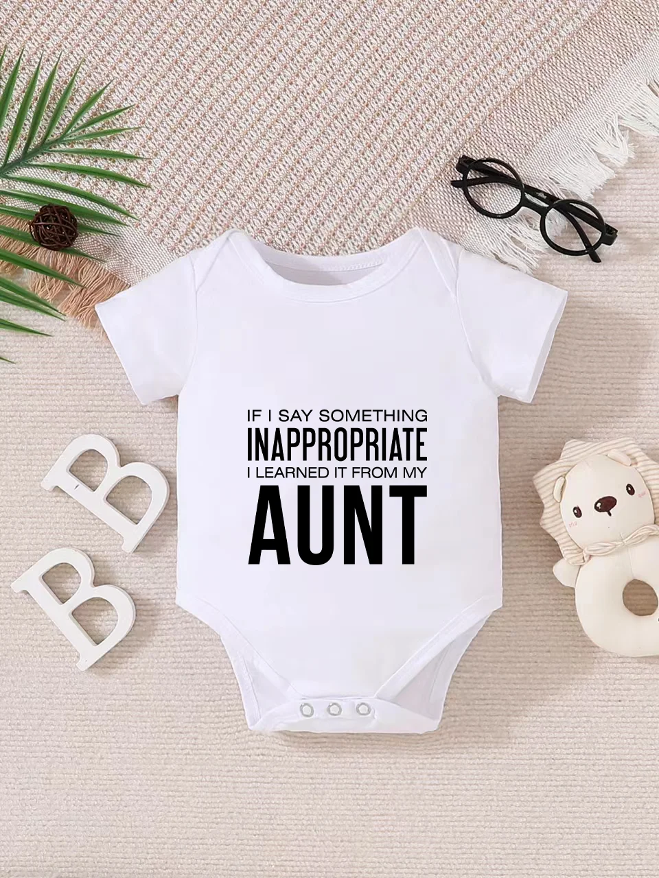 Playful letter-printed baby short-sleeve triangle bodysuit. Button closure for easy dressing, machine washable