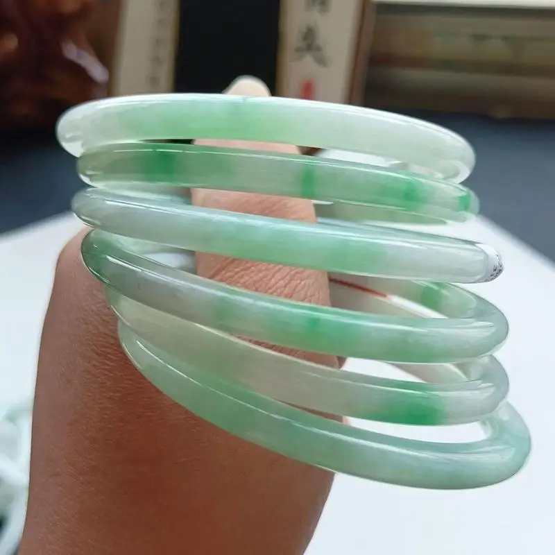 Fine jadeite bracelet with a watery, translucent white base and a bright green round band