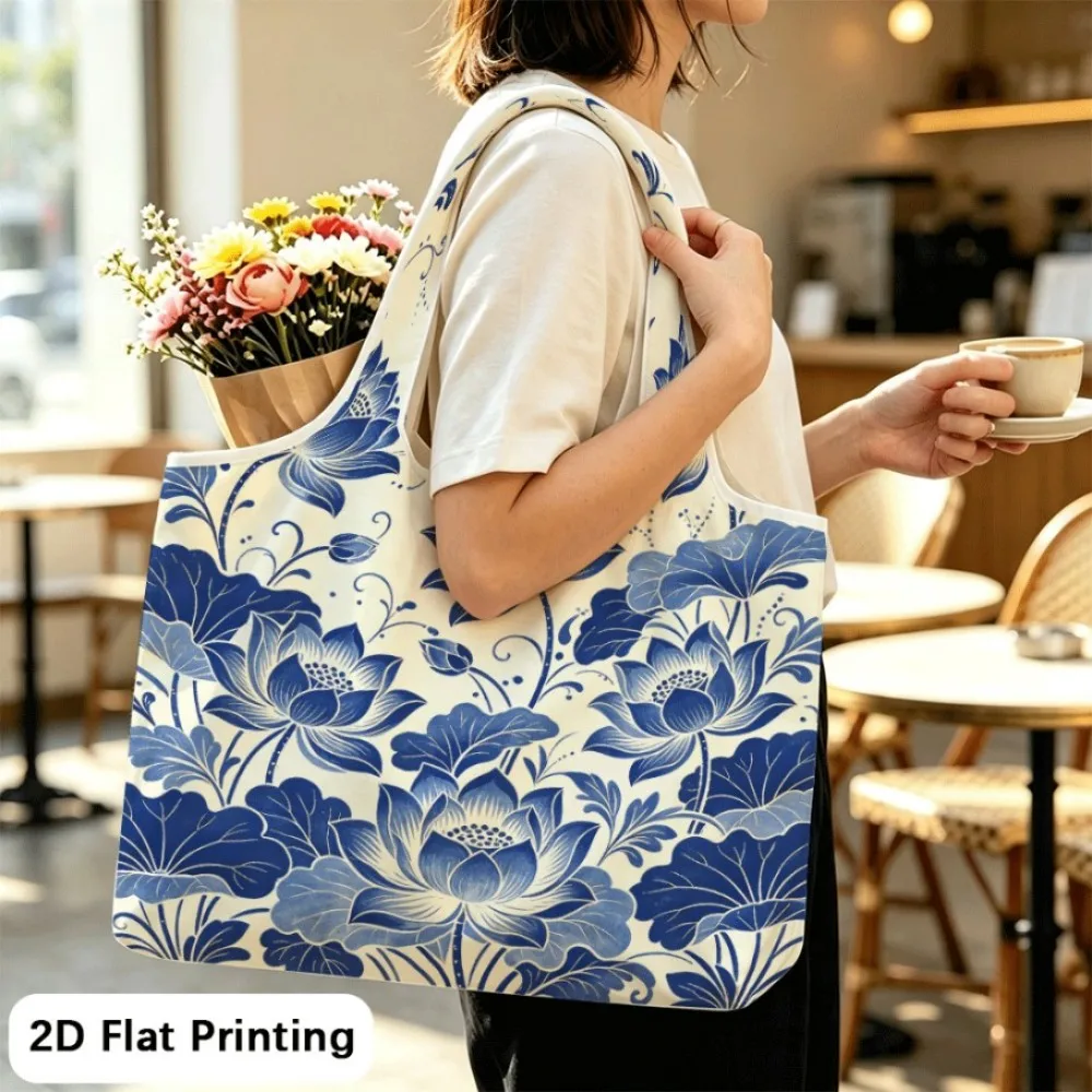 Lotus blooms in indigo scrolls Portable foldable tote bag, dual‑use as shoulder bag for outings.