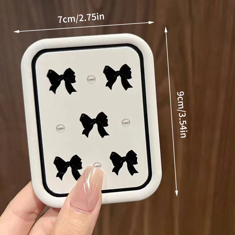 Miroir de maquillage rectangulaire portable avec design à nœud papillon rabattable et peigne intégré – Miroir cosmétique compact pour femme