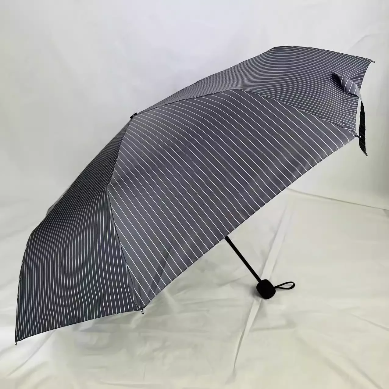 Triple fold light weight black checkered sun protection and shading and super large wind resistant sun rain dual-use umbrella