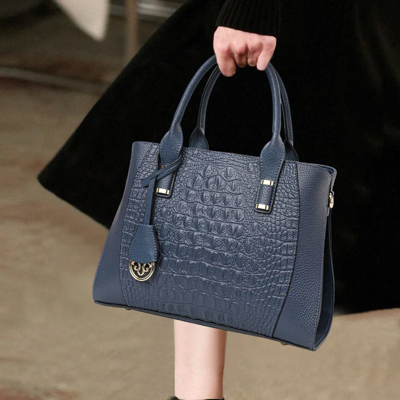 

Aidrani Structured Navy Handbag: Smooth Leather, Gold Detailing & Brand Appeal