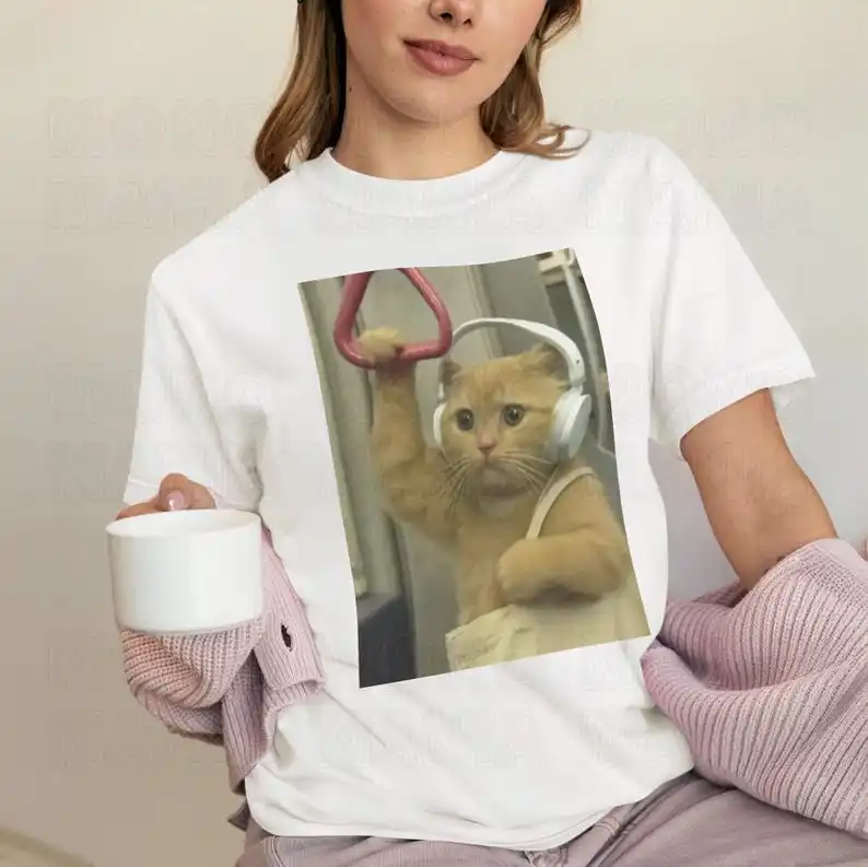 Anthropomorphic Commuting Cat Graphic T-Shirt (Human-Like Daily Scene Design + Soft Neutral Base + Cute Casual Style) T-shirts