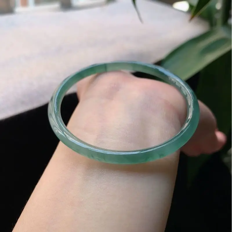 Natural Burmese old mine ice-type blue jade bracelet with green floral patterns, featuring fine, round strands; a small, delicat