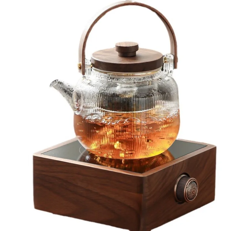 

Walnut electric ceramic stove, tea making utensils around the stove