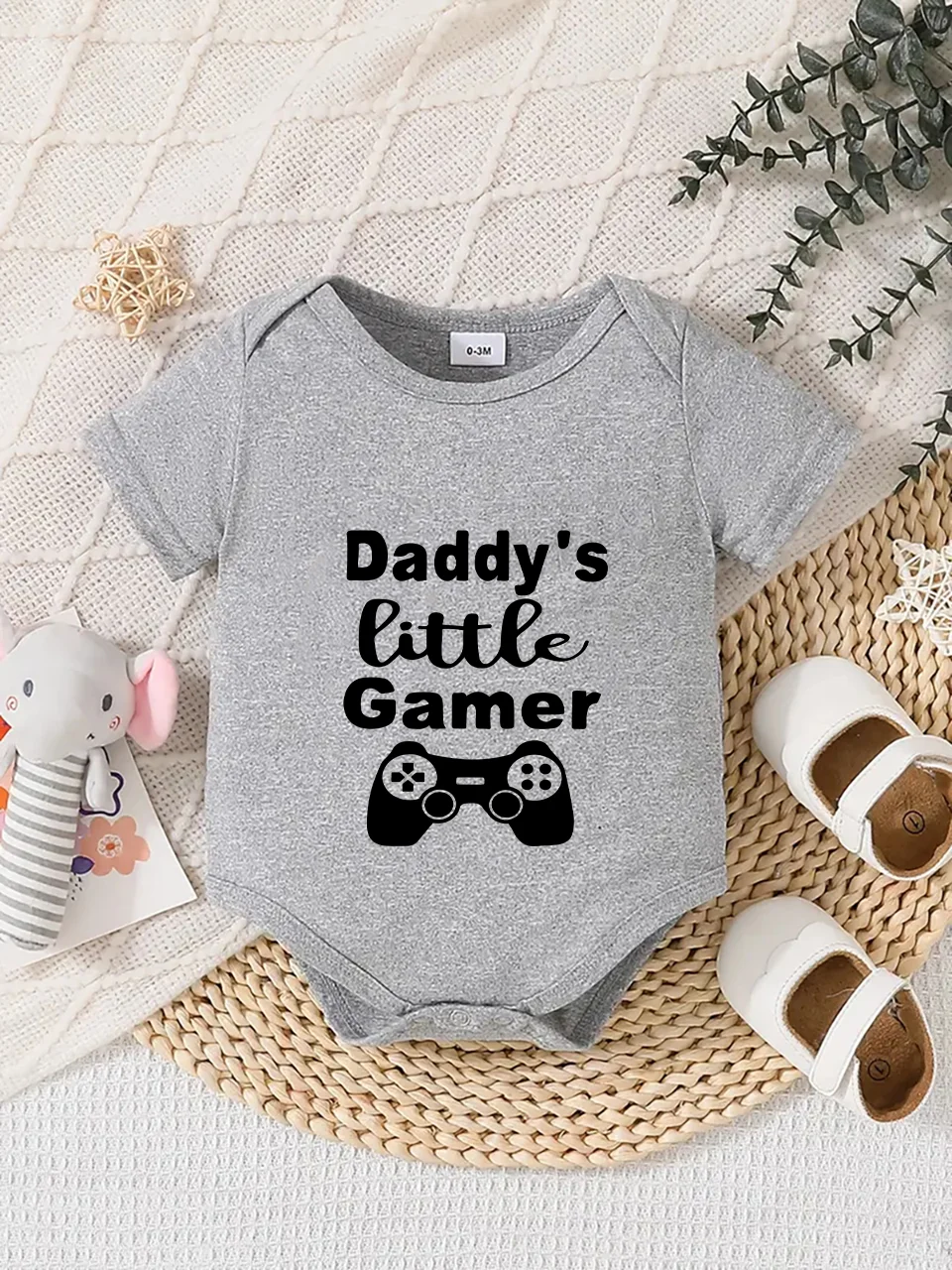 Playful letter-printed baby short-sleeve triangle bodysuit. Button closure for easy dressing, machine washable