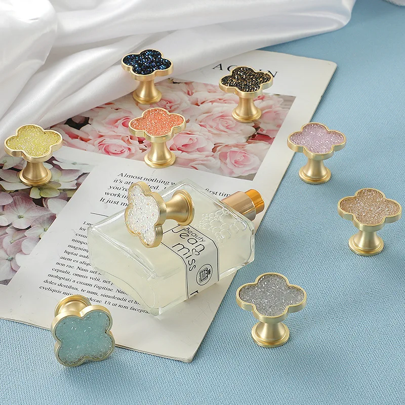 Shiny decorative drawer pulls for wardrobe cabinets; simple cabinet doors with single-hole small handles.