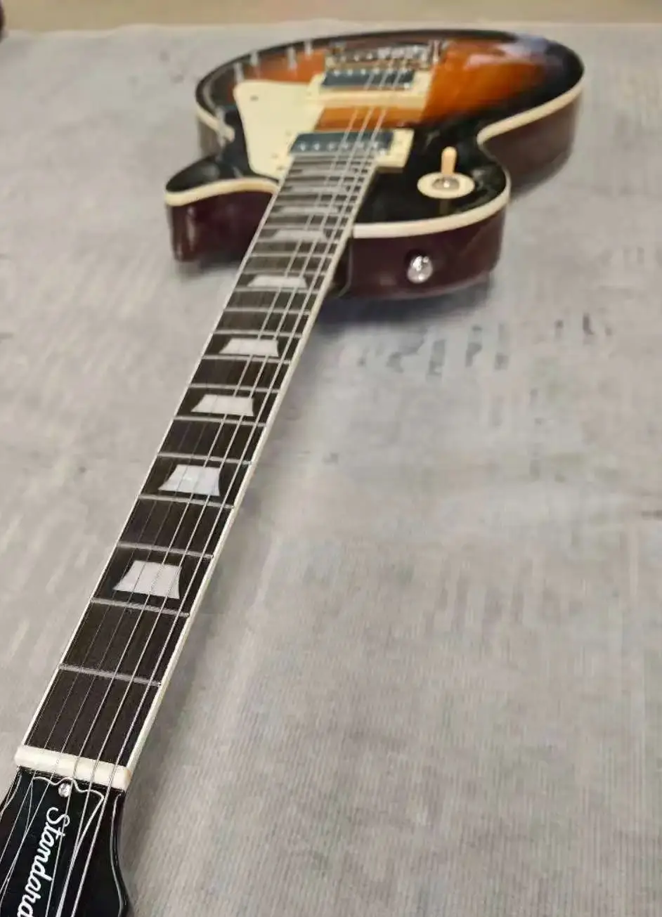 

Electric guitar made in China, with flame maple wood, bull horn bridge, and round head frets, and smooth string saddles.