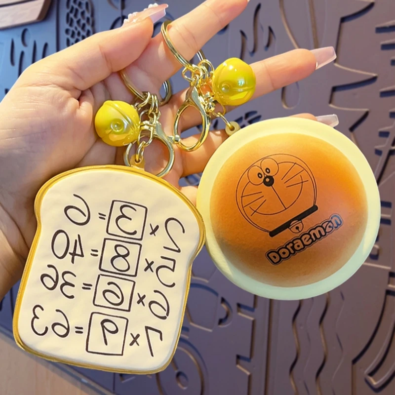 Doraemon Dorayaki llavero de rebote lento lindo colgante de pan de memoria bolso escolar de dibujos animados colgante juguete para niños regalo de cumpleaños