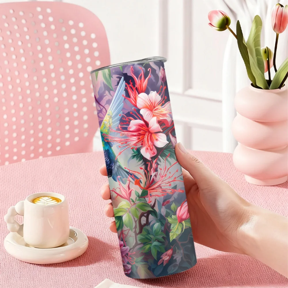 1pc 20oz straw water bottle, featuring a design of three hummingbirds flying among flowers, made of insulated stainless steel.
