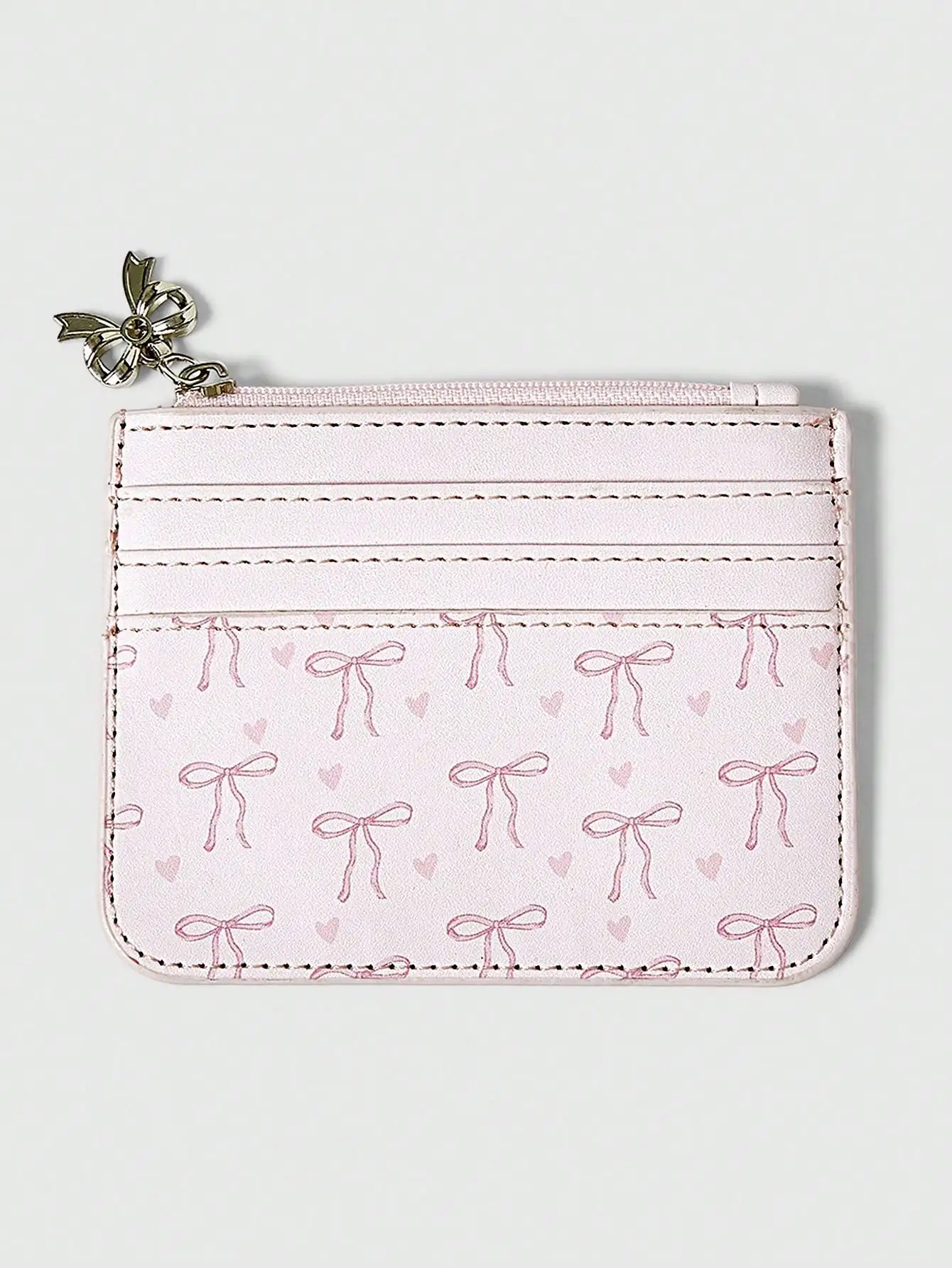 

Розовый картхолдер на молнии с принтом в виде банта и сердечек и подвеской