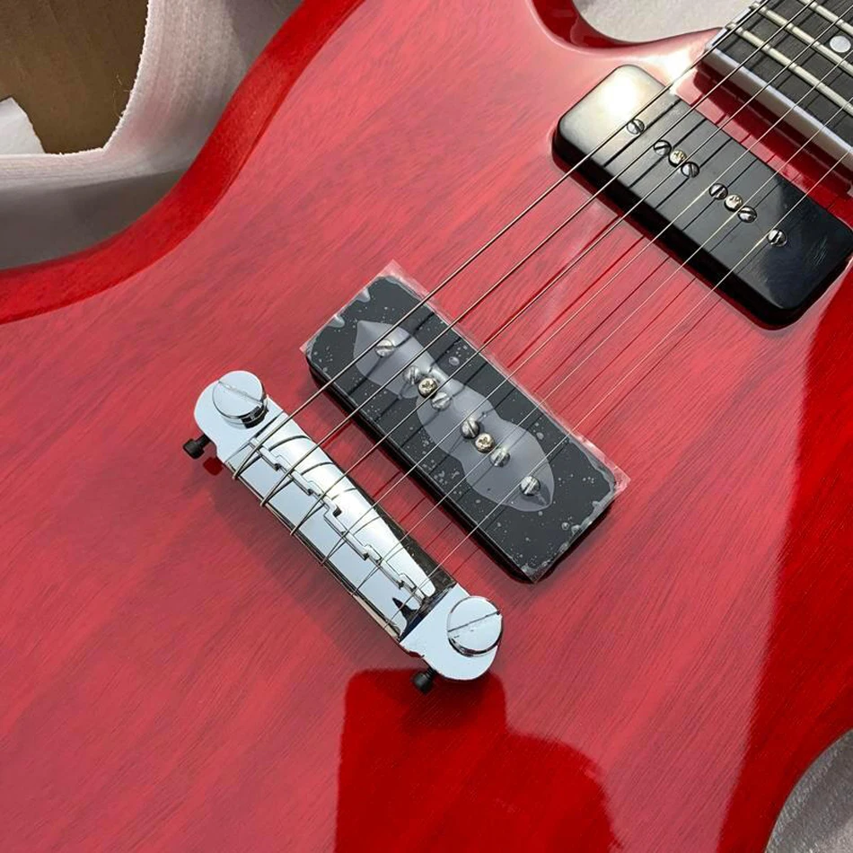 Transparent red ebony fingerboard electric guitar, wrapped around the bridge